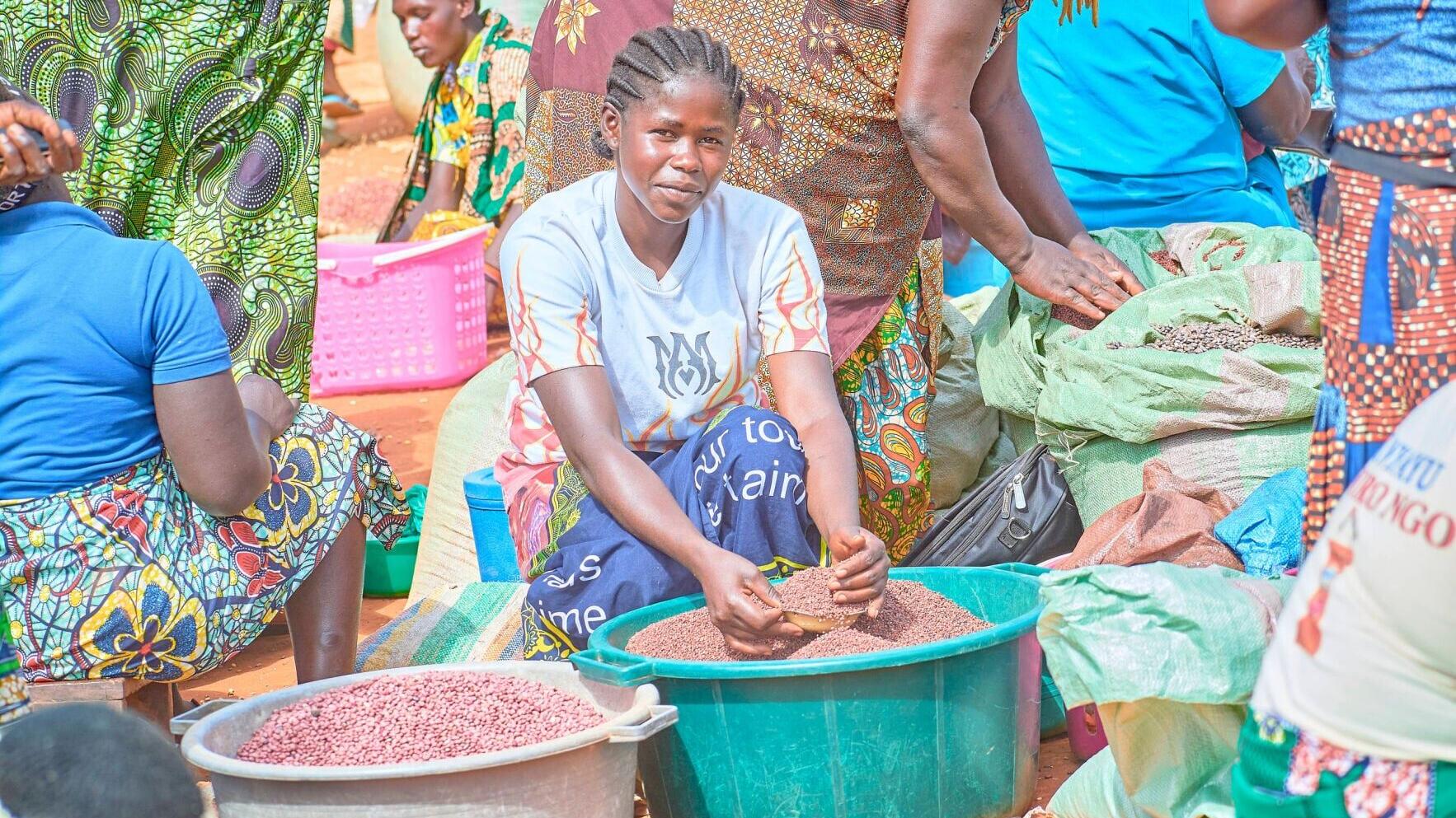Espérance, a displaced person who sells beans at the Kandoyi market,  located within the province of Ituri in Democratic Republic of the Congo. In the province of Ituri, Episcopal Relief &amp; Development supports long-term projects to reduce the spread of ...