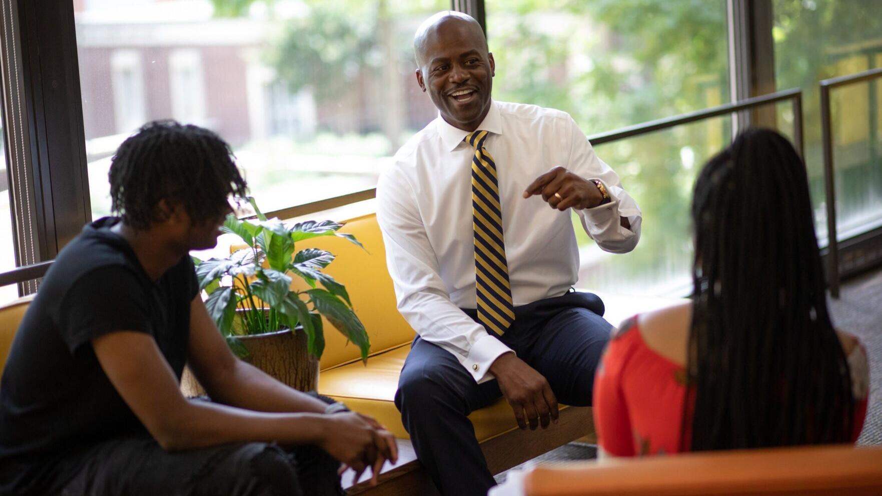 President Anthony L. Jenkins, Ph.D., engages with Coppin State students during an informal conversation on campus, reinforcing the university's commitment to student success, mentorship, and meaningful connections.