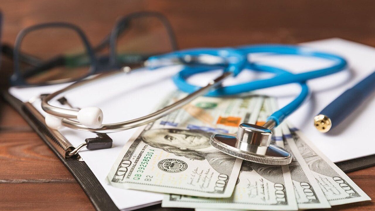 How does a medical expense reimbursement plan work with fully insured health plans?