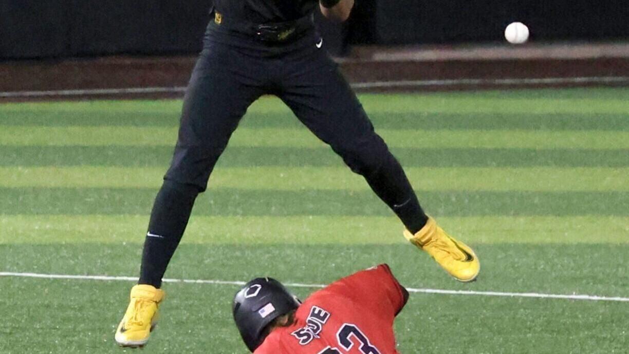 Mizzou infielder Blaize Ward, above, drops a throw while Daniel Gierer slides (copy)