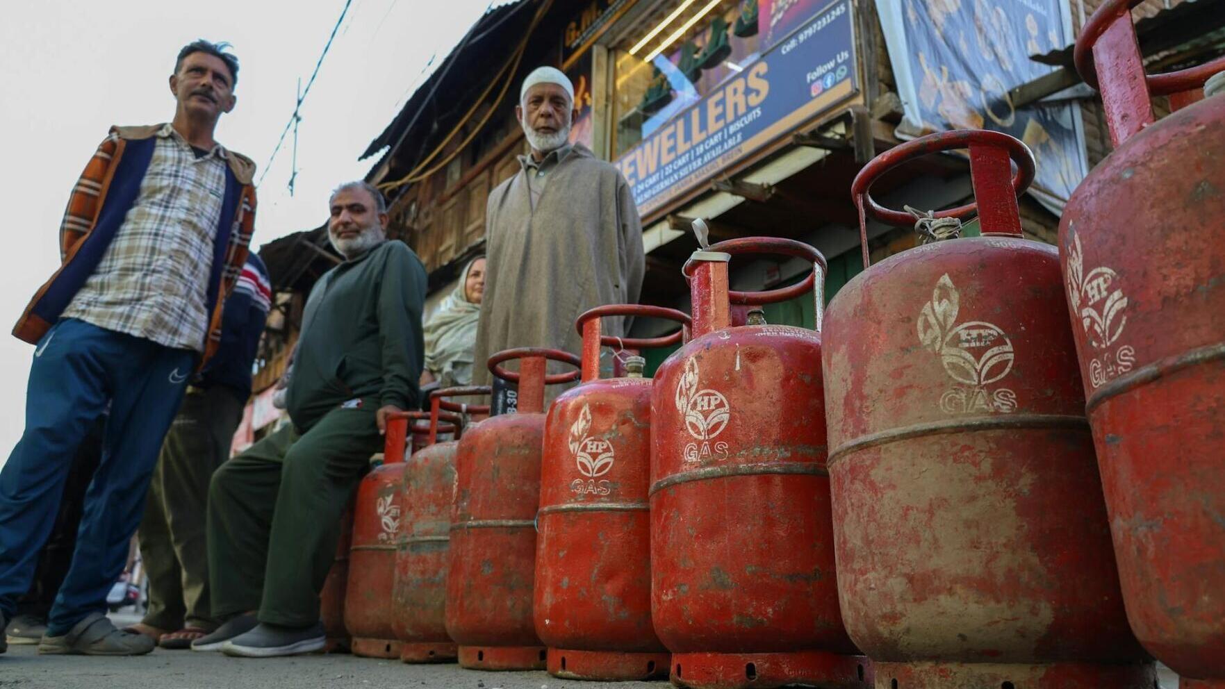 Customers stand with empty cooking-gas cylinders in Srinagar, India, waiting to be able to refill them.