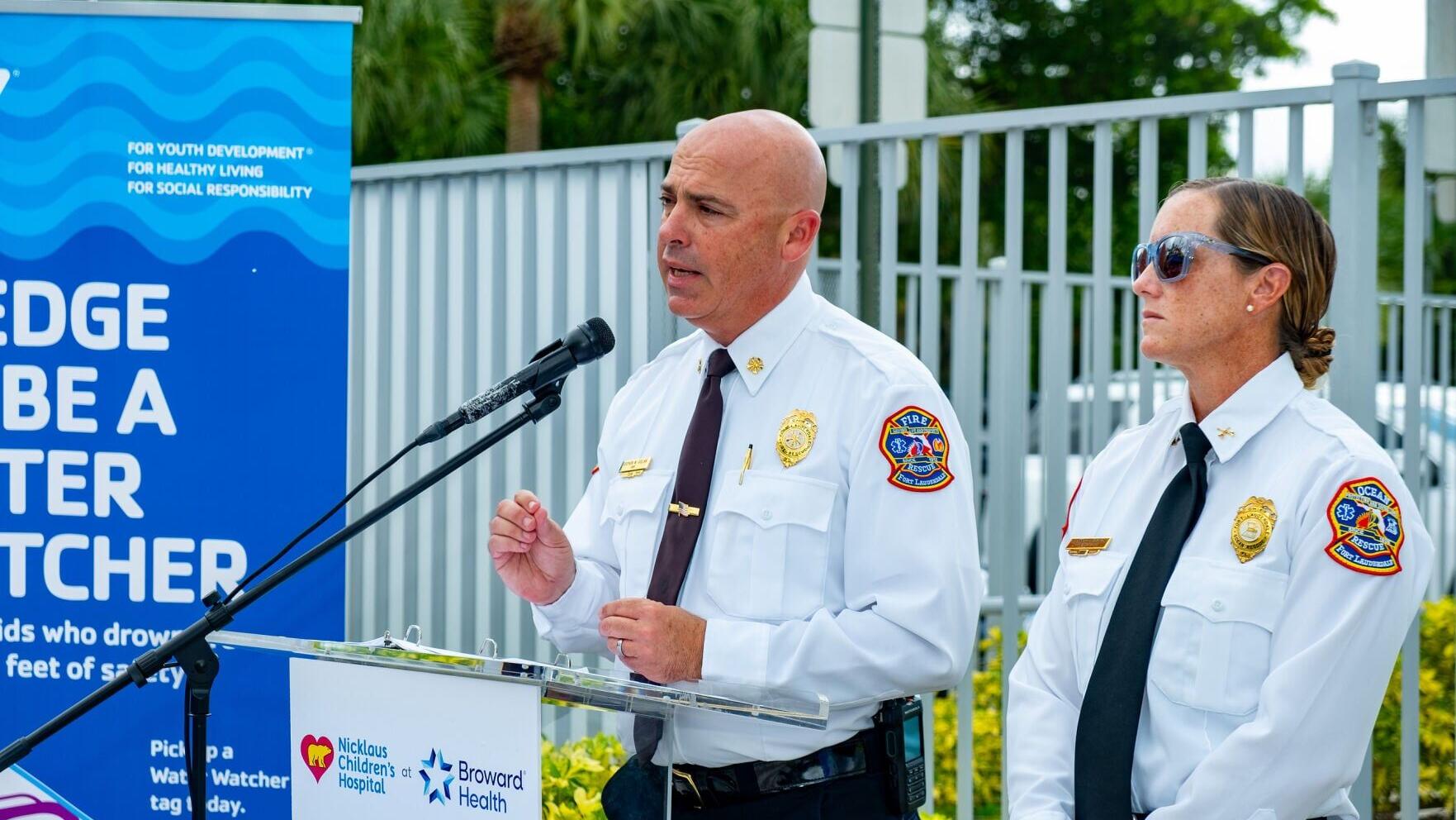 Stephen Gollan, Fort Lauderdale Fire Rescue Chief (left), along with Alex Bagwell, Fort Lauderdale Ocean Rescue Chief (right), address the media during a press conference about water safety at the L.A. Lee YMCA/Mizell Community Center on Wednesday, July...