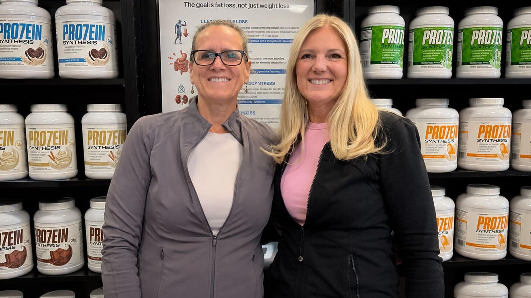 Valerie Rainville (left) lost more than 70 pounds while preserving lean muscle during her GLP-1 weight-loss journey with nutritional guidance and lifestyle support from Tracey Voyer (right), co-owner of Nutrishop Fitchburg.