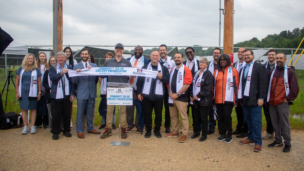 Representatives from New Energy Equity along with local officials and Harlem School District leaders and students at the project energization ceremony on June 24, 2026 in Machesney Park, IL.