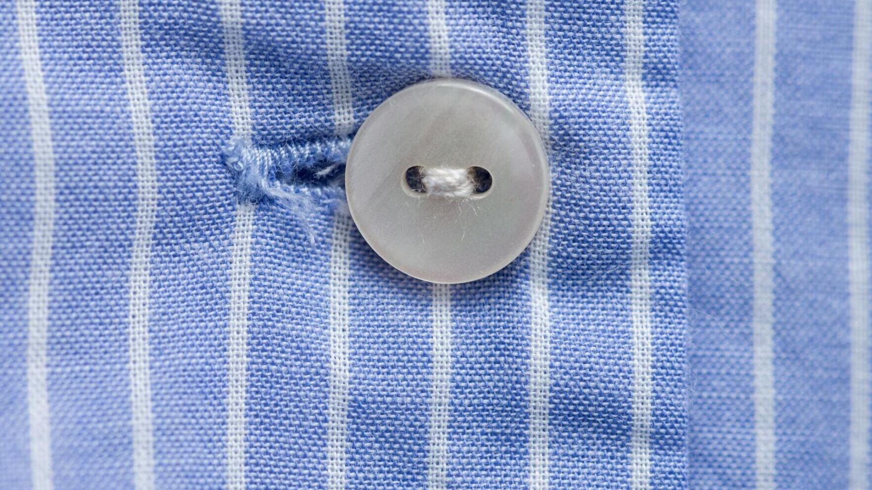 Is the person wearing the clothes fastening their own buttons?