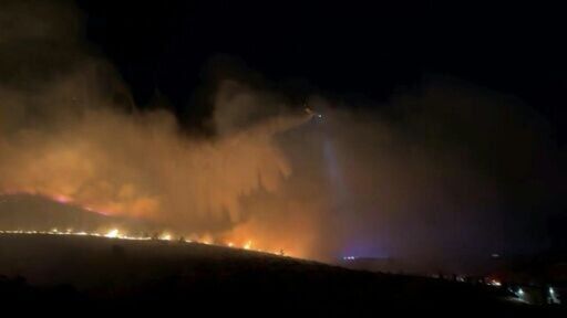 Authorities in Nevada urged tens of thousands of people to evacuate and ordered schools to remain closed as a fast-moving, wind-driven wildfire bore down on the western US city of Reno