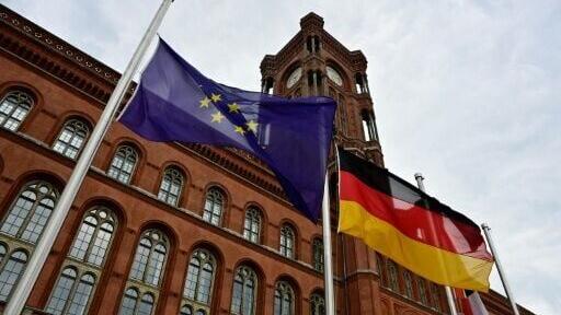 The flags of European Union, Germany and Berlin fly at half-mast in front of Berlin's city hall (Rotes Rathaus)