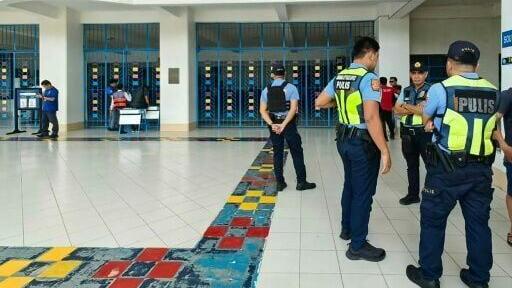 Philippine police gather at a school following the shooting in Zamboanga