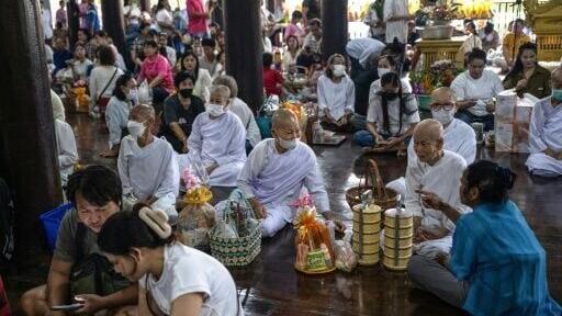People gather to mark the start of Buddhist Lent at Wat Nong Song Hong Buddhist temple in Samut Sakhon province on July 30, 2026