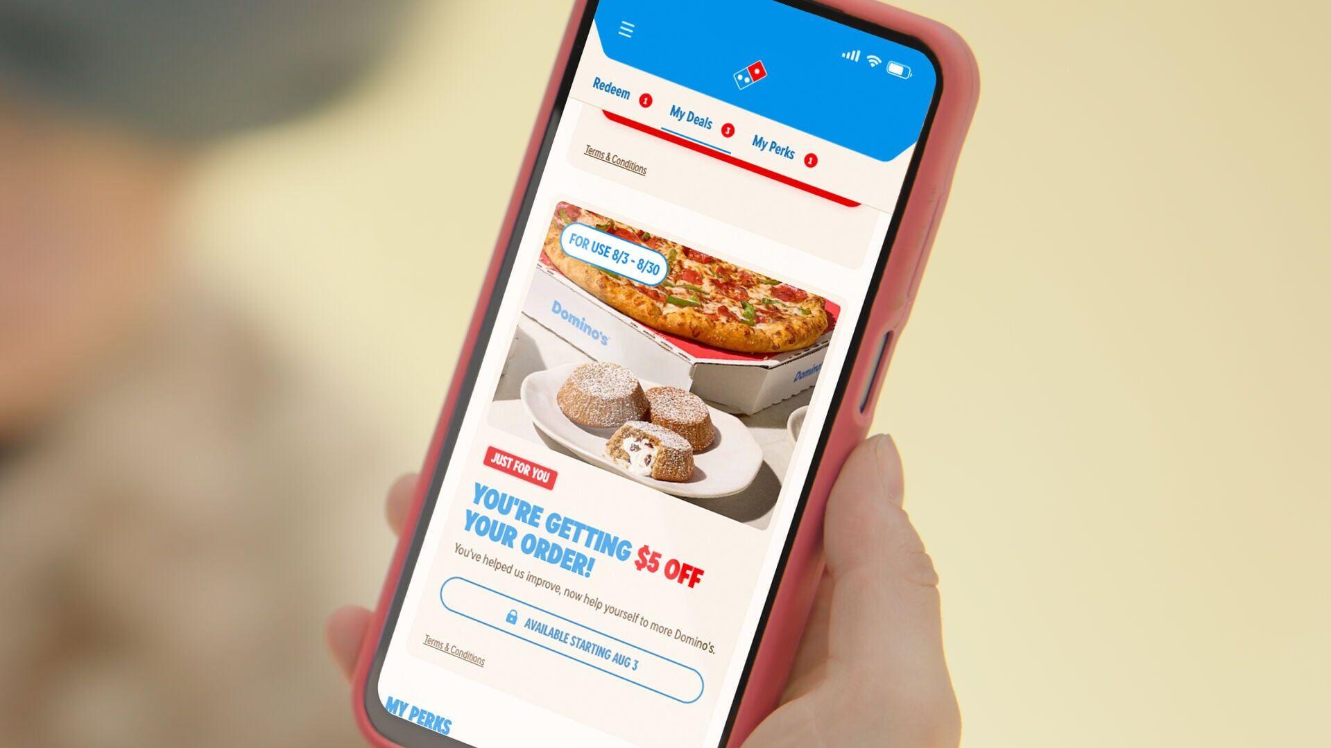 Domino’s is paying customers to try its new digital ordering experience by giving them $5 off their next order.