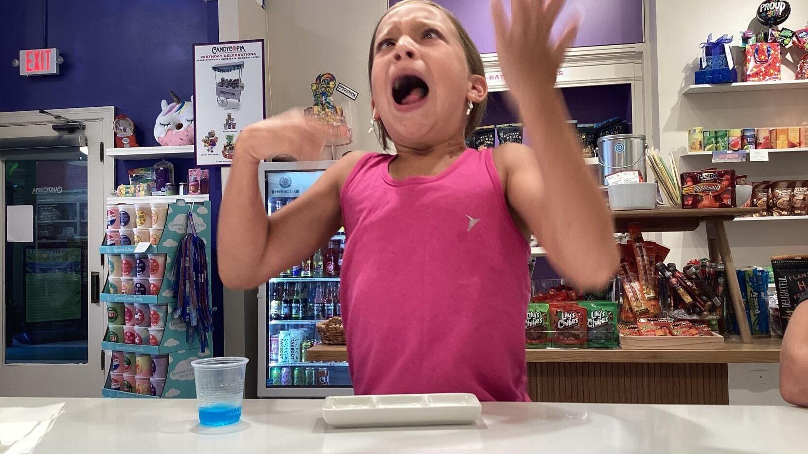 THE ULTIMATE PUCKER FACE: A young participant reacts to an intensely sour treat during Candycopia's 2023 Sour Candy Challenge. The local candy boutique is bringing back the challenge this summer alongside an official GUINNESS WORLD RECORDS™ title attemp...