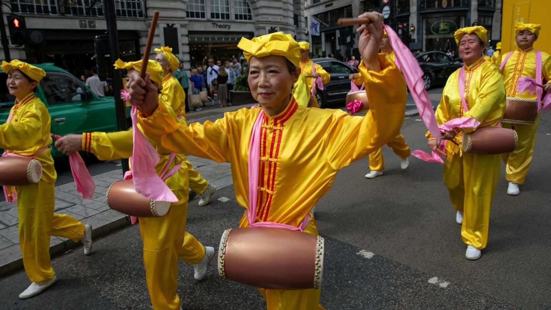 Falun Gong practitioners march in London, calling for an end to persecution by the Chinese Communist Party.