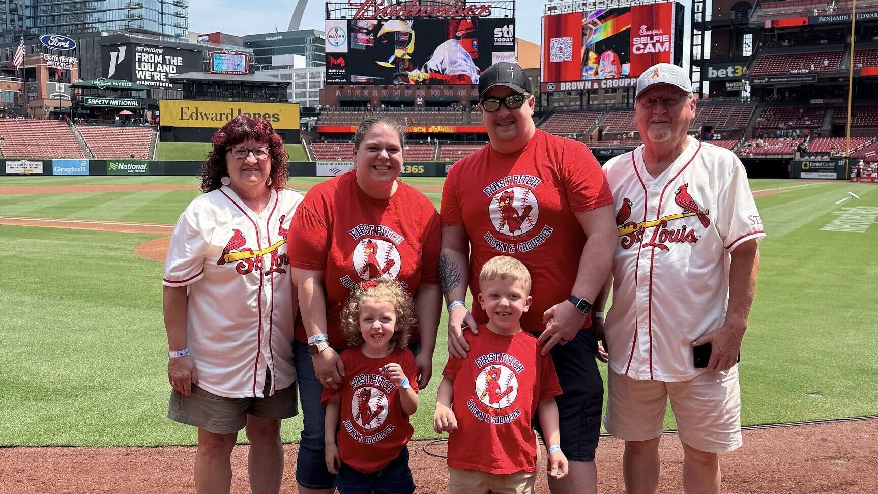 Four-year-old Ollie with his family at Busch Stadium, where he threw out a ceremonial first pitch during a St. Louis Cardinals game as part of Brown &amp; Crouppen’s partnership with Rainbows for Kids, creating a special ballpark experience for Ollie and hi...
