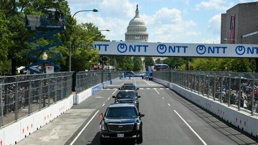 US President Donald Trump rides in the presidential limousine, known as "The Beast," on the track prior to the start of the IndyCar Freedom 250 Grand Prix in Washington