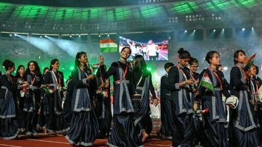 Members of India's delegation wave their country's national flag