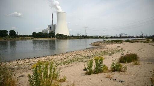 The partially dried-up river bed of the Rhine near a power station in Duisburg