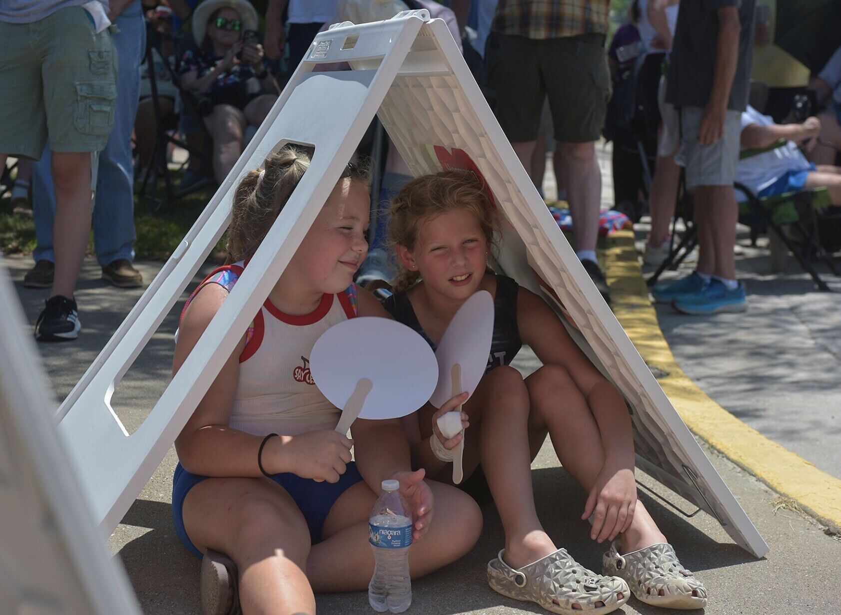 From left, Genna Zelch, 10, and Arabella Velasco, 11, sit in the shade