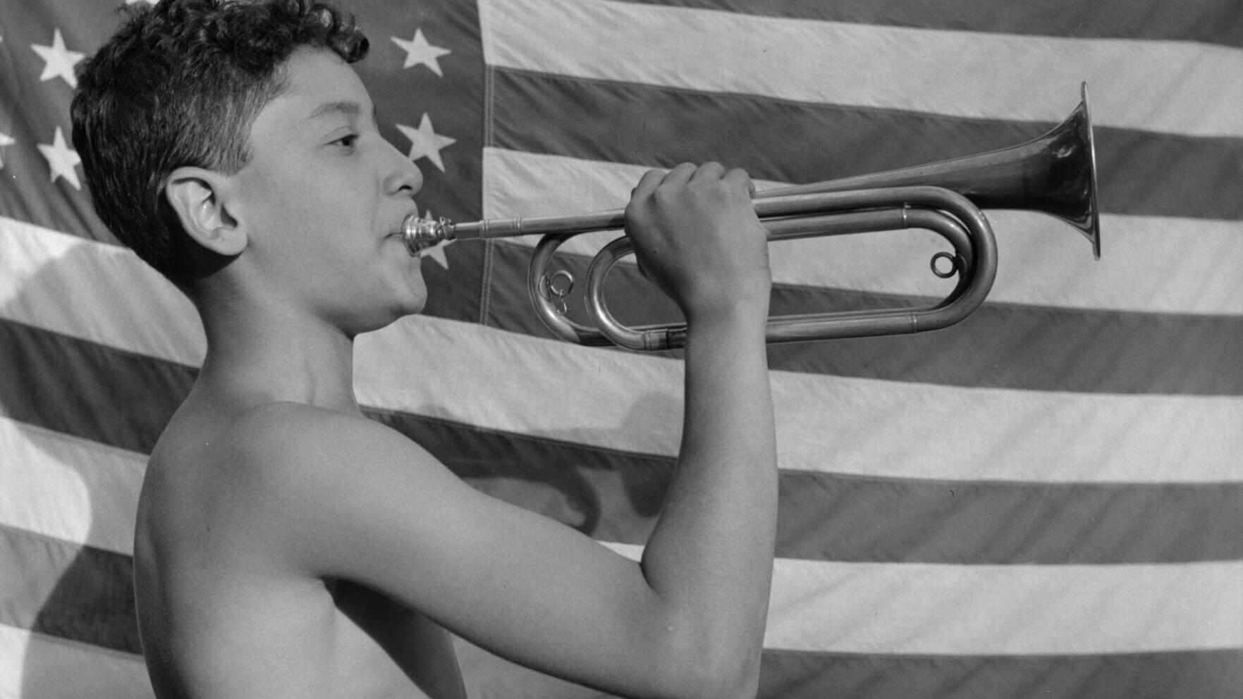 A camper blows a bugle at Camp Nathan Hale in upstate New York in 1943.