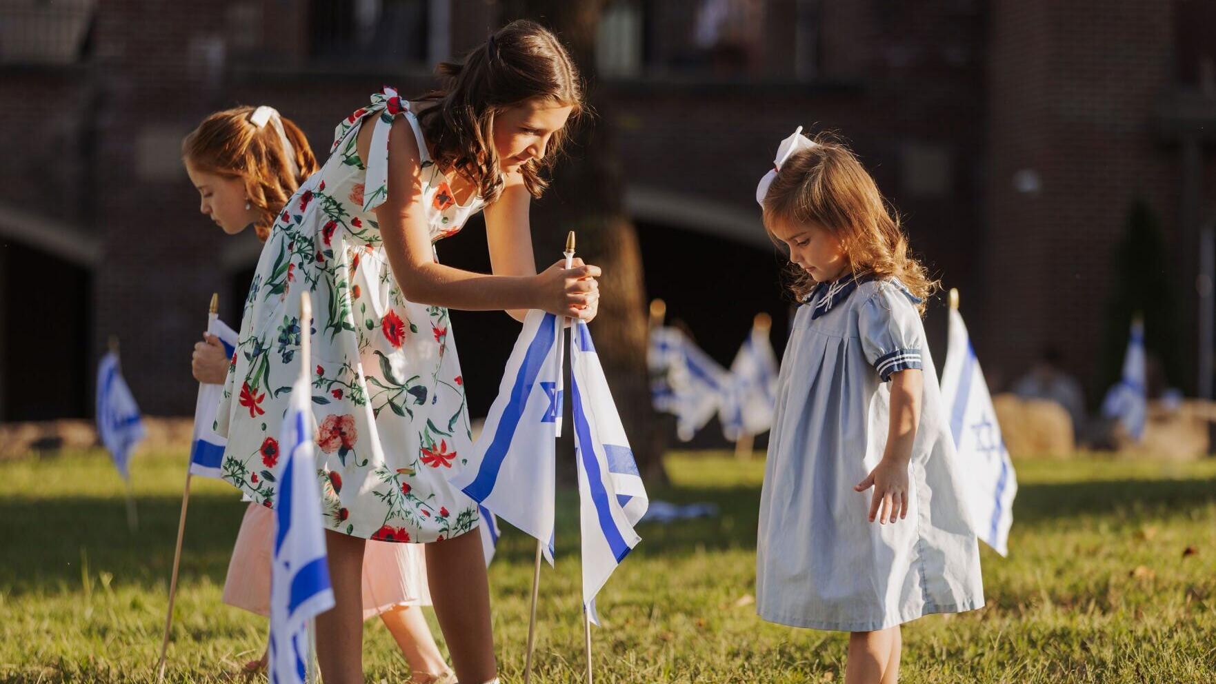 A family plants Israeli flags at World Outreach Church in Murfreesboro, Tenn. as part of the Flags of Fellowship event on Oct. 4, 2025. Over 1,350 churches, synagogues and organizations participated in the IFCJ-led campaign last year. Photo Credit: Worl...