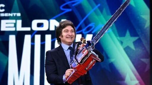 Argentina's President Javier Milei, seen here holding a chainsaw in 2024, has been hailed for his success in fighting high inflation, but slower price increases are a double-edged sword for people living on credit