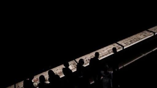 Britain's King Charles III and Britain's Queen Camilla alongside France's President Emmanuel Macron and his wife Brigitte Macron view sections of the Bayeux Tapestry during a preview event for the Bayeux Tapestry Exhibition, at the British Museum