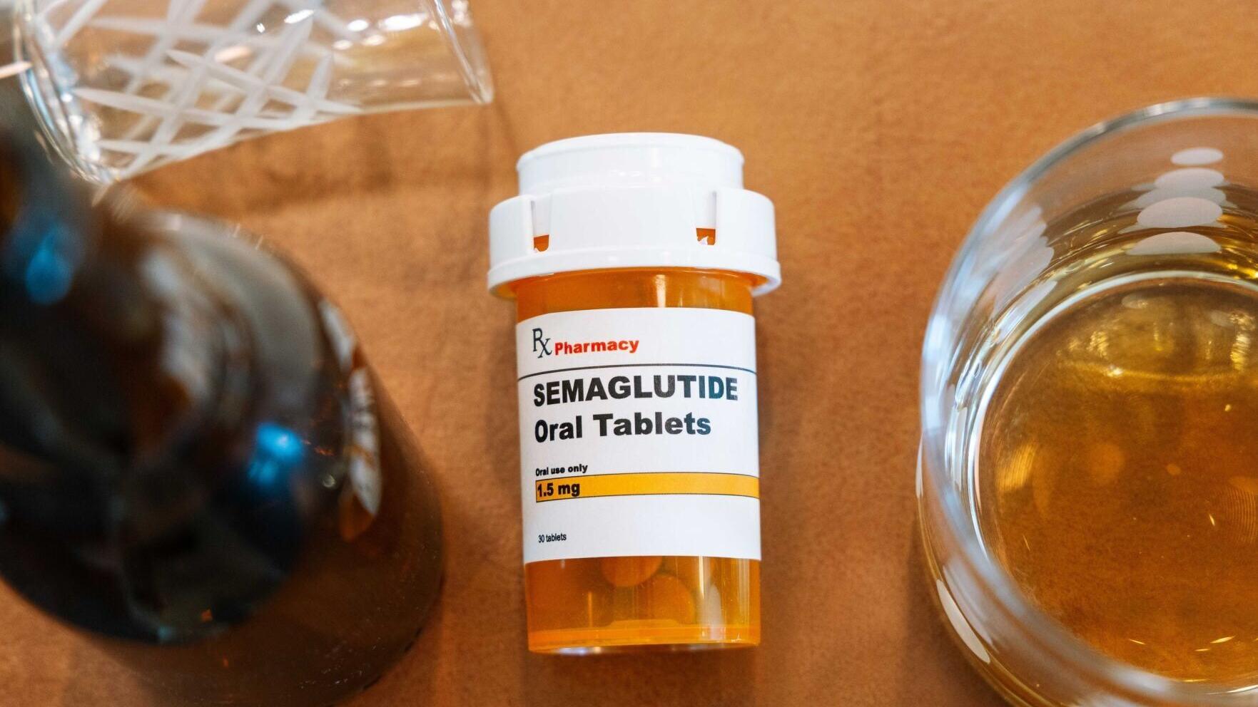Photo of semaglutide bottle with beer bottle and glasses of alcohol