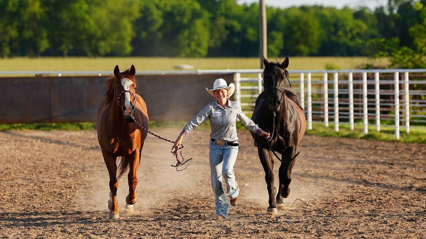 Kail Wood, 15, runs with her horses