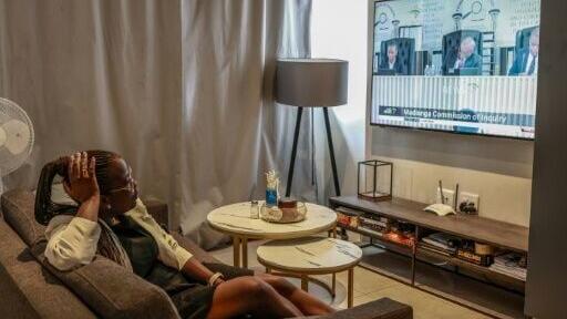 Mulumbwa Luchen settles in front of the television to binge the Madlanga commission