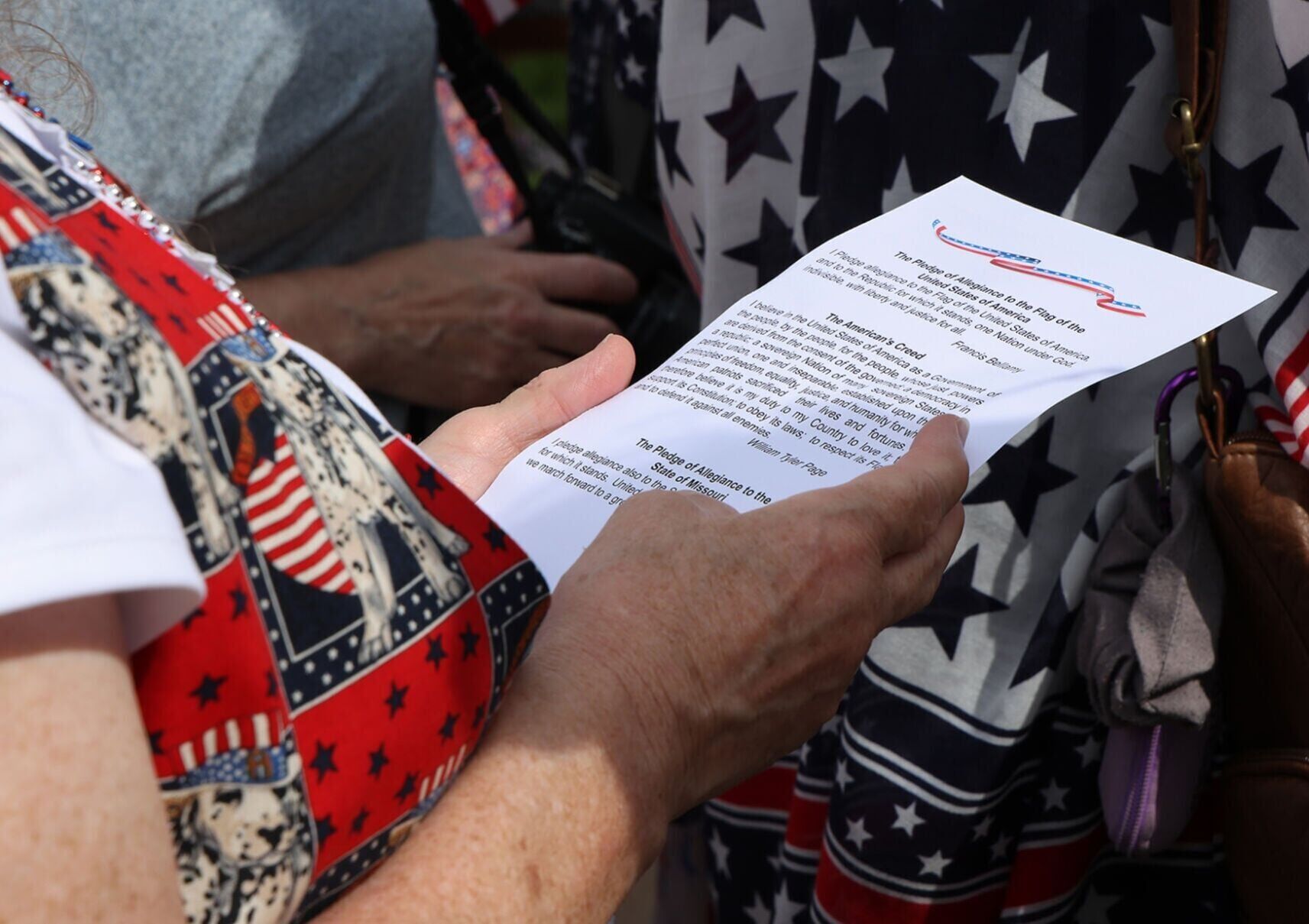 A guest holds the pamphlet and reads