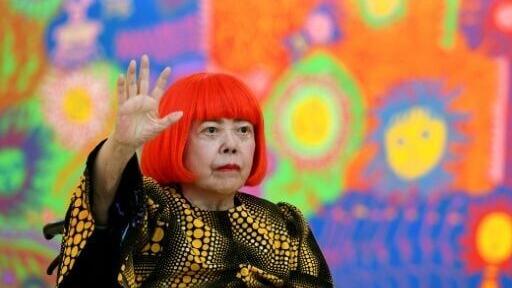 (FILES) Japanese artist Yayoi Kusama waves at a photo session during a press preview of her exhibition titled "My Eternal Soul" at the National Art Center in Tokyo on February 21, 2017. Japanese avant-garde artist Yayoi Kusama, known as the "polka dot q...