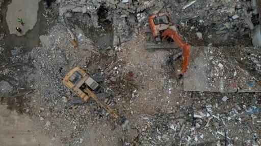 An aerial view of a backhoe removing debris in Pereira, Colombia, one of the worst-hit cities from last Monday's quake