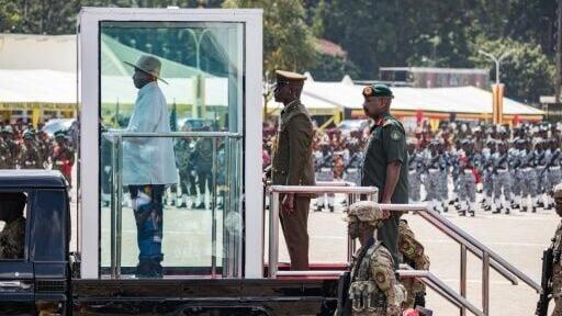Speculation mounts over who will succeed Ugandan President Yoweri Museveni (L on vehicle)