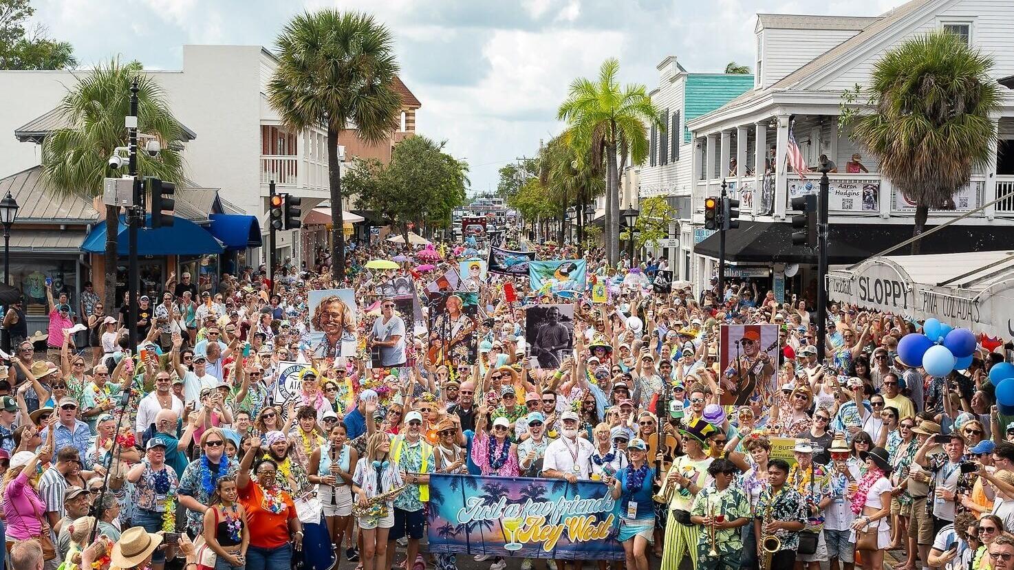 Fans of the late Jimmy Buffett parade along Duval Street in Key West, Fla., during the 2025 "Just a Few Friends" festival celebrating the famed singer-songwriter's life and legacy. The third annual festival is scheduled Sept. 3-7, 2026, on the island Bu...