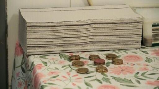 Coins on the table for the Vienna toilet attendant, who collects 50 cents from each toilet stall user (though urinals are free of charge for men)