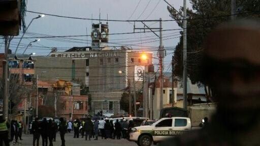 Police secure the area around an army barracks after a powerful explosion that killed at least two people