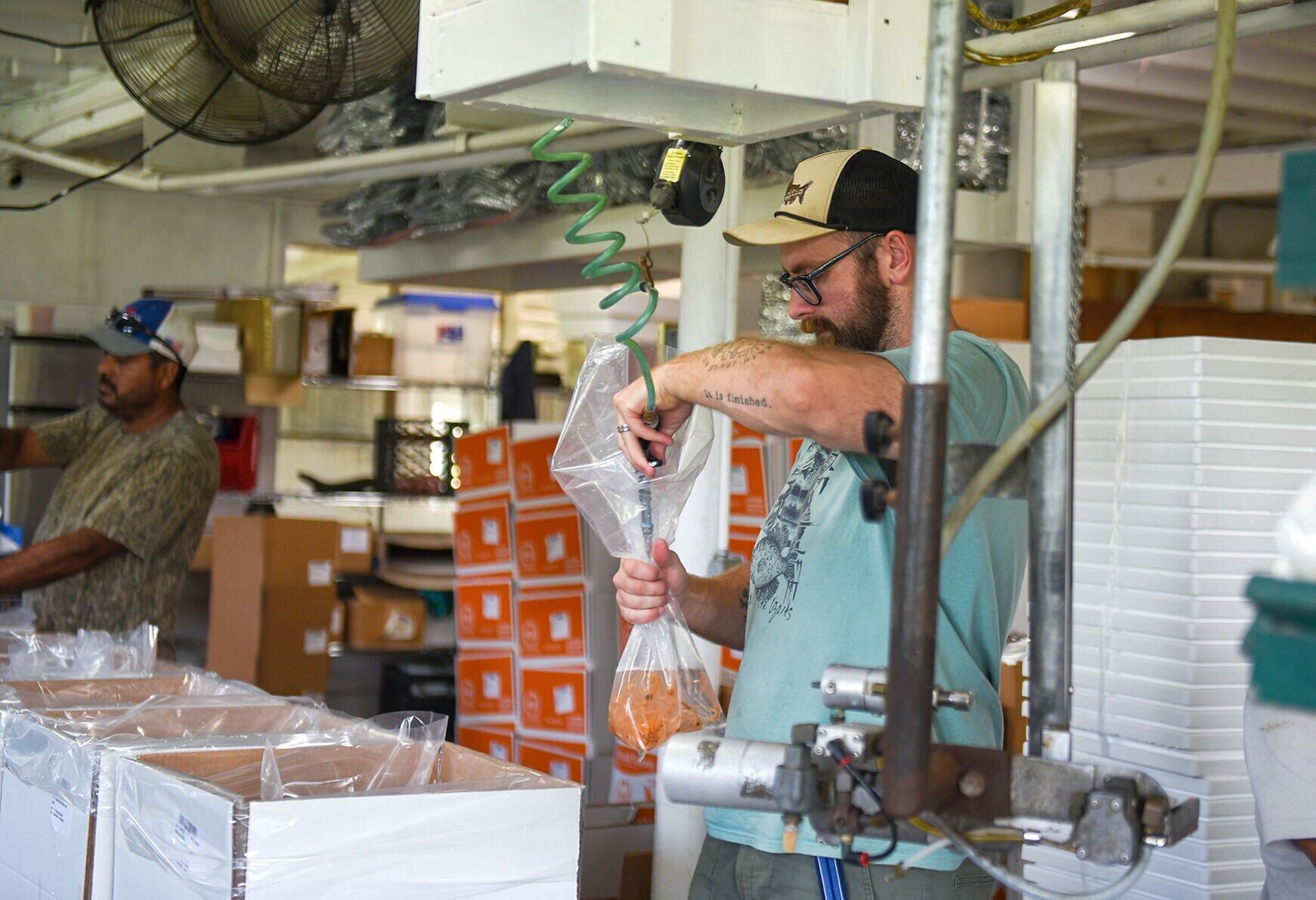 Michael Boure adds air to a bag of goldfish