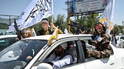 People packed into cars, spilled out of windows, sunroofs, or the back of pick-up trucks, waving the bright white flag of the Taliban government