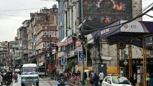 A digital billboard (top, R) displays the condolences after the death of mountaineer Nirmal Purja and his companions by an avalanche in Pakistan