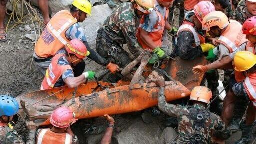Nepal Army personnel carry a worker who was trapped inside a tunnel, during a rescue operation at Trishuli-3A Hydropower Project in Nepal's Rasuwa district