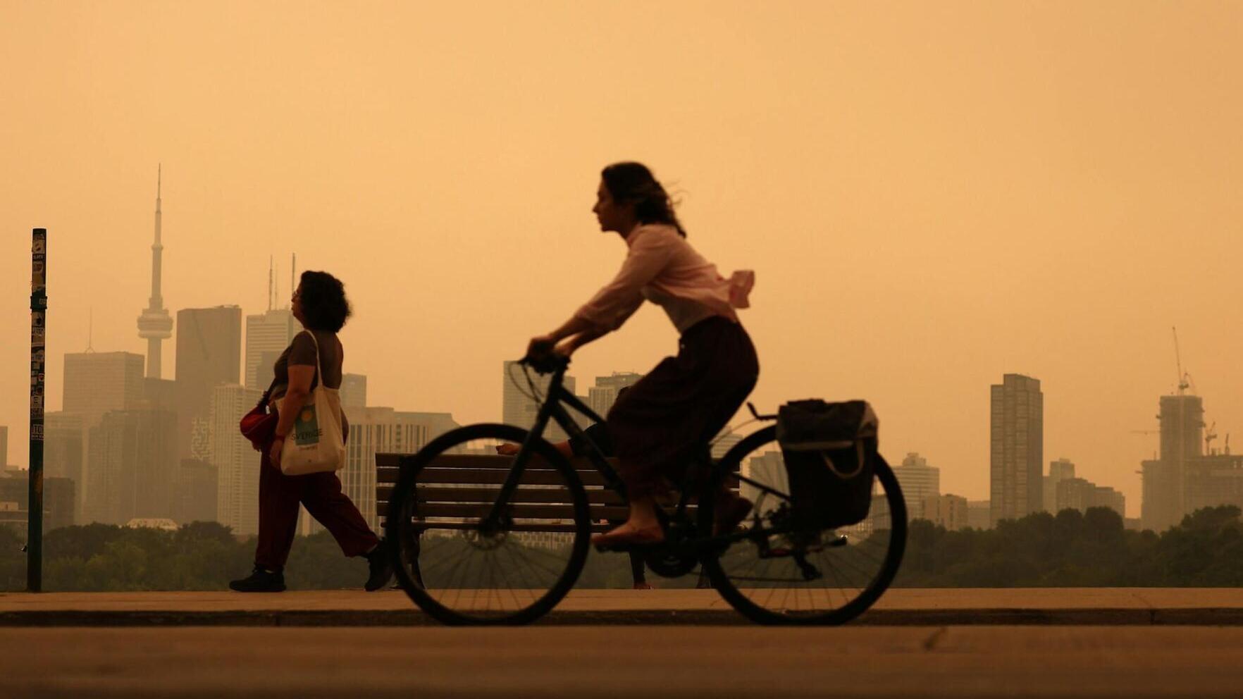 Heavy wildfire smoke from Canada's forests turn skies orange in Toronto and across parts of the U.S. in July 2026.