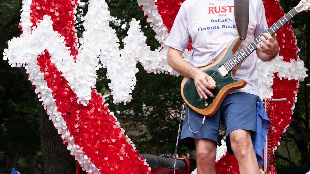 A member of The Rust Band performs atop the Advance ER float during the Park Cities Fourth of July Parade. The band provided live music throughout the parade as Advance ER celebrated Independence Day alongside the Park Cities community.