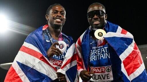 Silver medallist Jeremiah Azu (L) and gold medallist Romell Glave celebrate after the men's 100m