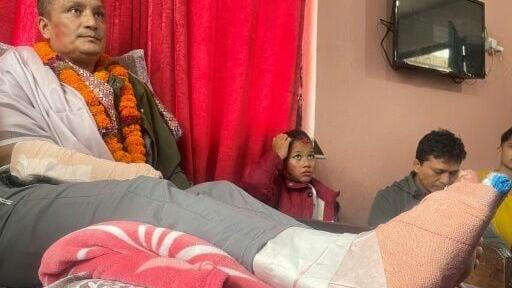Nepali flood survivor Kabir Maharjan, who was rescued from a hydropower project tunnel, takes part in an interview with AFP at his home in Kirtipur on September 25, 2026, after being discharged from hospital.