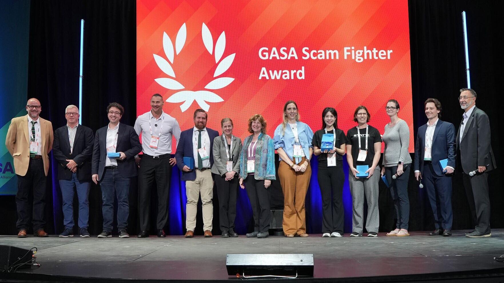 ScamAdviser Head of Growth, Yuying (fifth from the right), receives the Scam Fighter Award for Watchmen at GASS America 2026