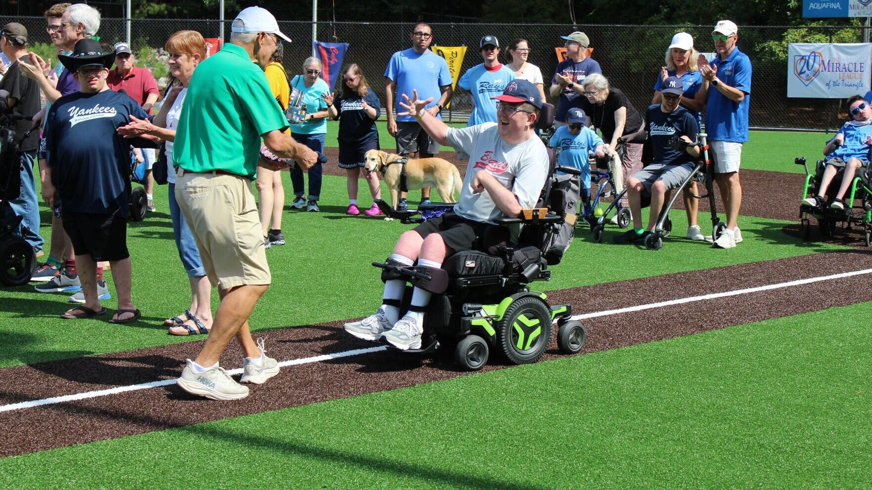 Miracle League of the Triangle Co-Founder Tony Withers with 20-Year Player Bryson Dew