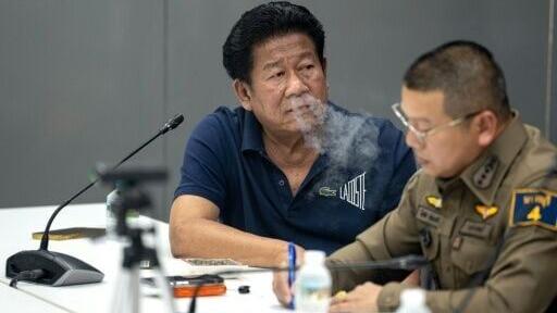 Former MP Chalong Riewrang at a police station in Thailand's Nonthaburi province, after being arrested over the shooting