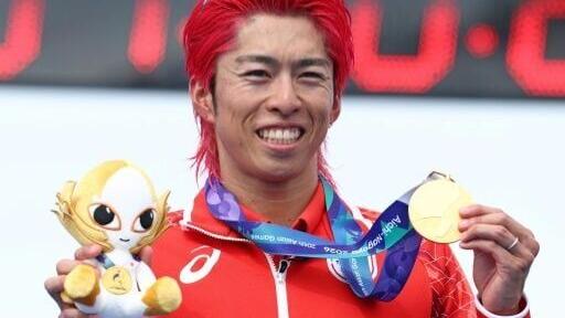 Japan's Takumi Hojo holds the first gold medal of the Asian Games after winning the men's individual triathlon in Gamagori city near Nagoya