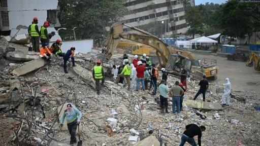 Rescue teams and volunteers search for bodies amid the rubble of a collapsed building in Caraballeda, Venezuela, on August 3, 2026