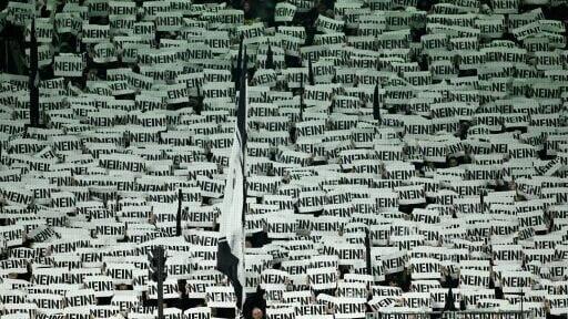 Fans of Borussia Moenchengladbach hold up signs saying "no" in a protest at the introduction of personalised tickets in the Bundesliga