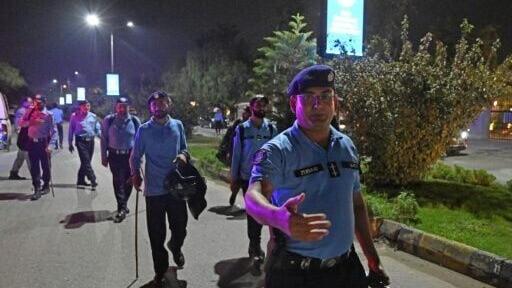 Security personnel clear the road outside the Shifa International Hospital in Islamabad